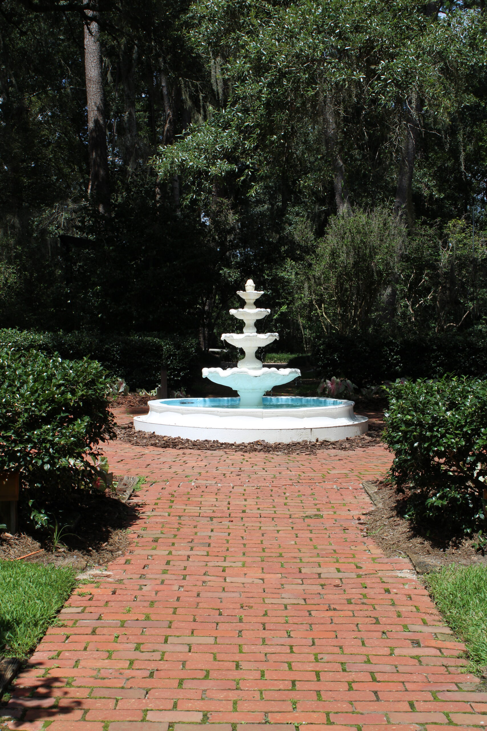 Image of a fountain in a red brick path. Fountain can be found at Dorothy Oven Park. Having beautiful landscaping helps sellers homes move quickly.