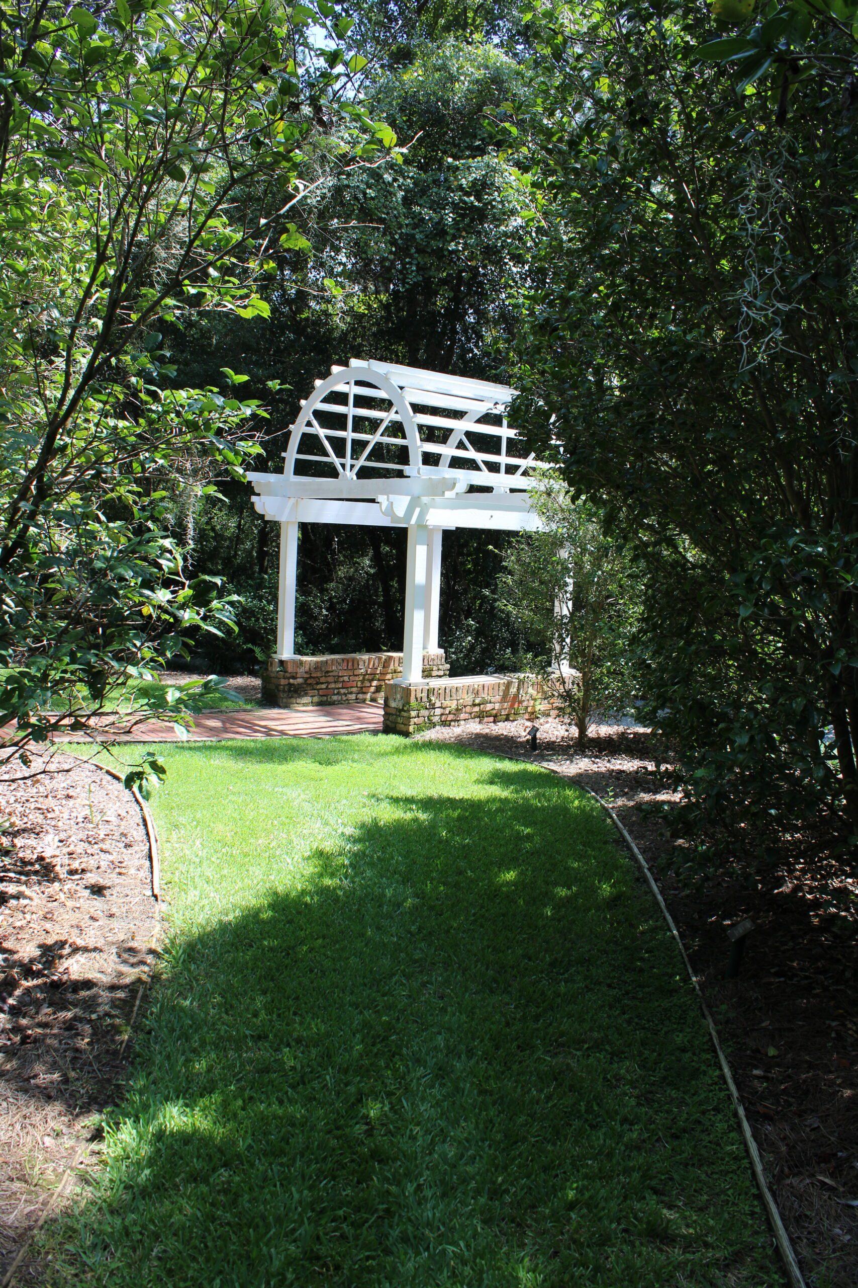 Decorative photo taken by a Tallahassee real estate agent. Shows a white pergola with a bridge. This can be found at Oven Park on Thomasville Road