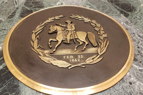 Emblem on the floor of the capitol rotunda. Shows a crest with a man riding a horse